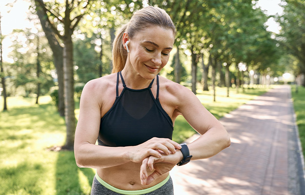 VGH-Mature-woman-looking-at-her-watch-checking-the-result-while-running-in-a-park-ss-2-NMN-Increases-Energy-Levels