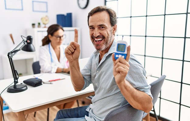 VGH-Middle-age-man-at-doctor-clinic-holding-glucose-meter-ss-4-NMN-Enhances-Insulin-Sensitivity