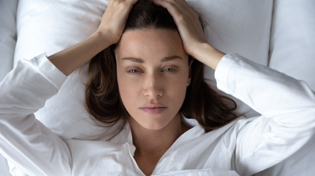 caucasion-woman-in-bed-looking-tired-How-Long-Does-Period-Fatigue-Last-ss