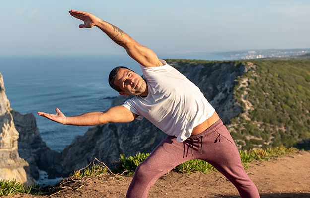 man-doing-yoga-outdoor--The-Principles-of-Holistic-Medicine---px-body