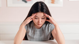 photo-of-a-woman-with-her-hands-on-her-head-In-Her-Mind’s-Turmoil-Recognizing-Symptoms-of-Stress-in-Women---px-feat