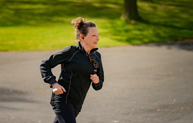 woman-in-active-wear-jogging-on-gray-asphalt-road----Benefits-&-Drawbacks-of-Holistic-Medicine---px-body