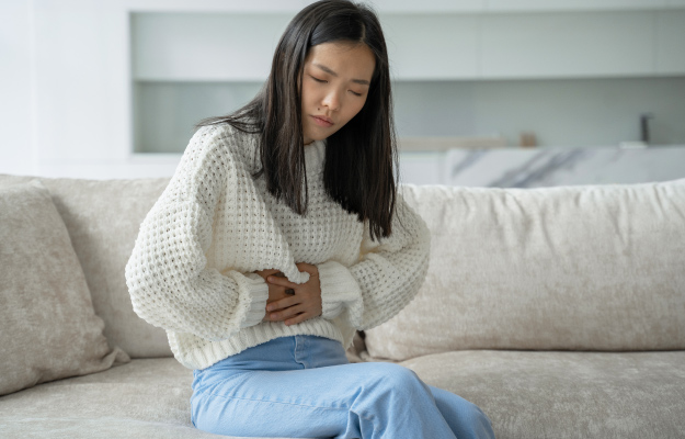 An-Asian-woman-has-Bloating-10-Signs-of-An-Unhealthy-Gut-1-Bloating