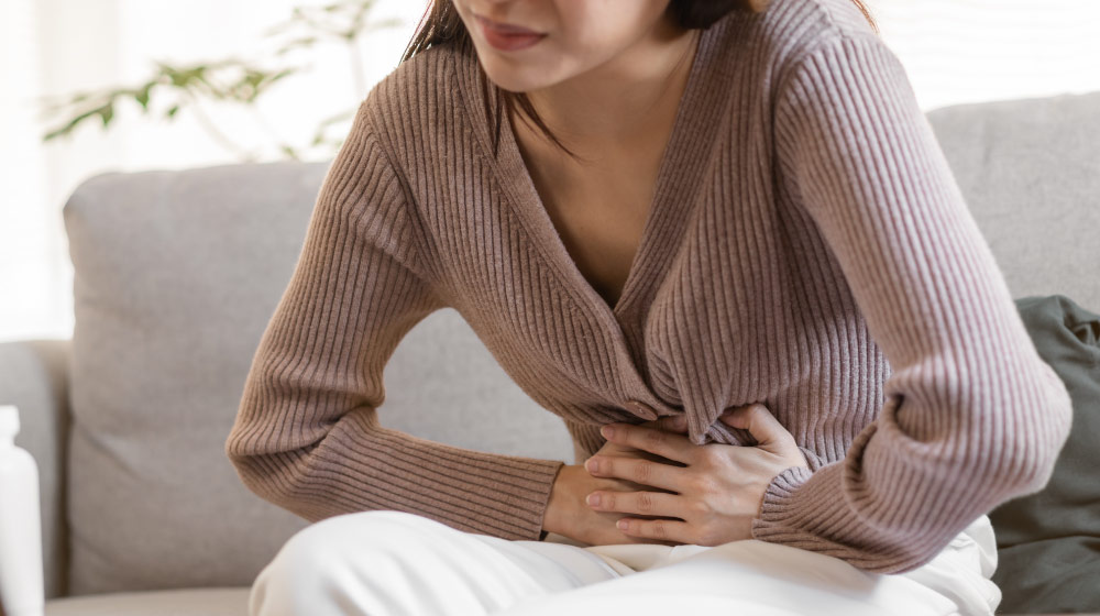 girl-hand-in-stomach-ache-Is-Your-Gut-Trying-to-Tell-You-Something-10-Signs-of-an-Unhealthy-Gut