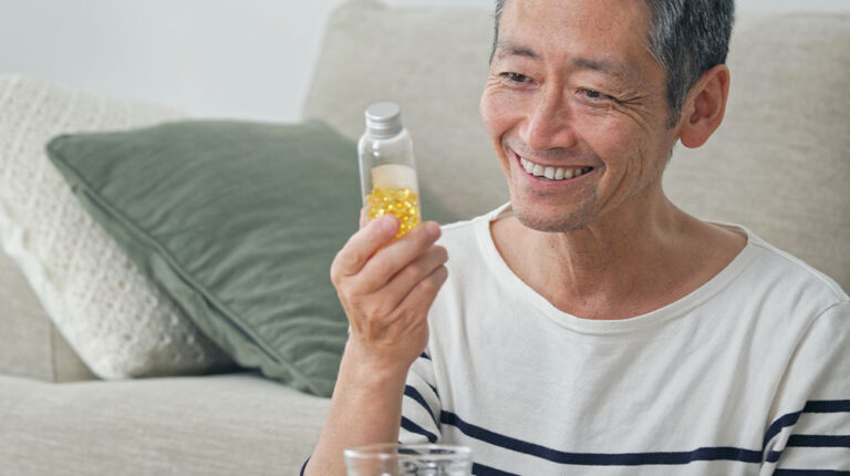 VGH-Middle-aged-asian-man-taking-supplements-ss-10-Best-Bone-Health-Supplements-That-Keep-Your-Bones-Strong-as-You-Age-Gracefully-bone health supplements