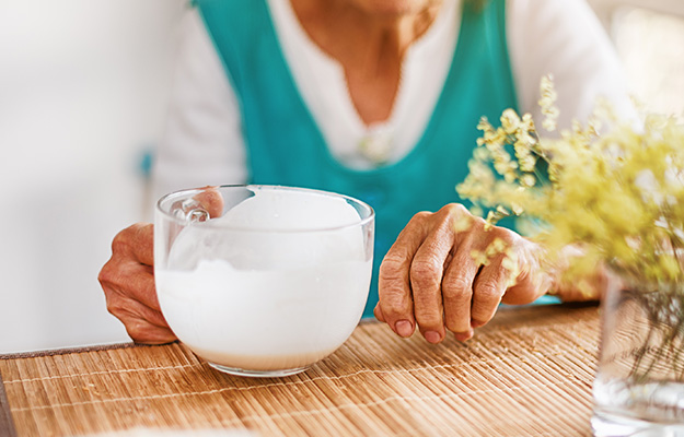 VGH-Old-woman-holding-a-glass-of-milk-ss-5-Zinc